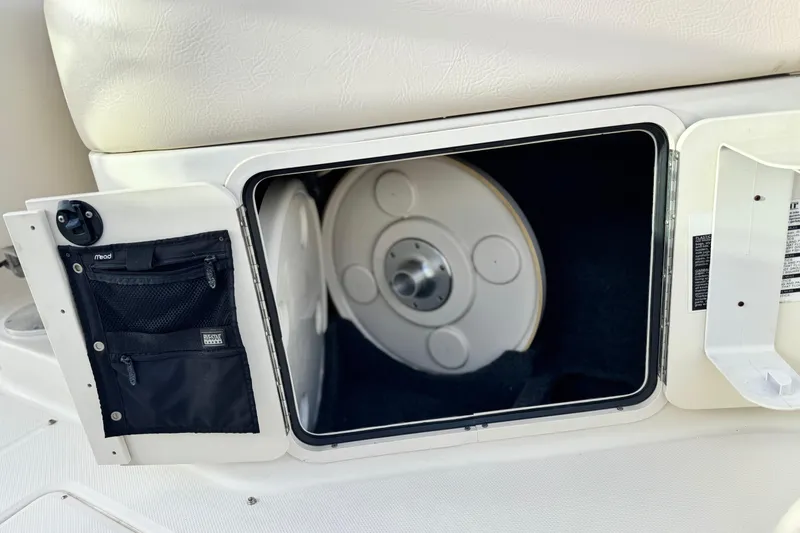 Slide: The Image of Storage compartment on a 2001 Sea Ray 240 Sundeck boat with netted pocket. - 27