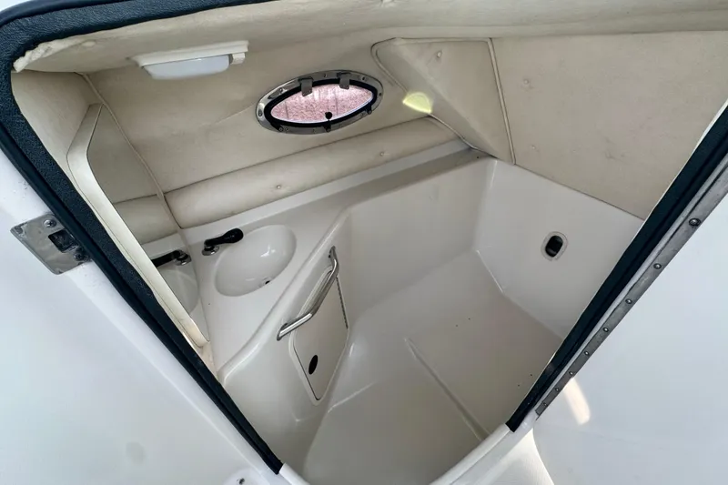 Slide: The Image of Interior of 2001 Sea Ray 240 Sundeck boat, featuring compact bathroom amenities. - 32