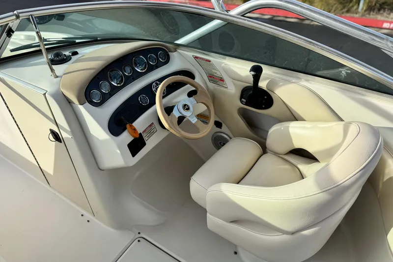 Slide: The Image of 2001 Sea Ray 240 Sundeck boat interior with steering wheel and control panel. - 33