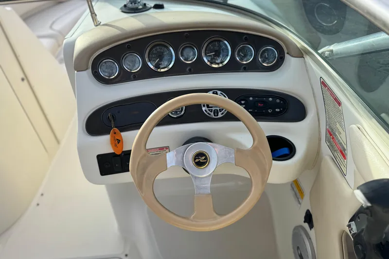 Slide: The Image of Steering wheel and dashboard of 2001 Sea Ray 240 Sundeck boat. - 34