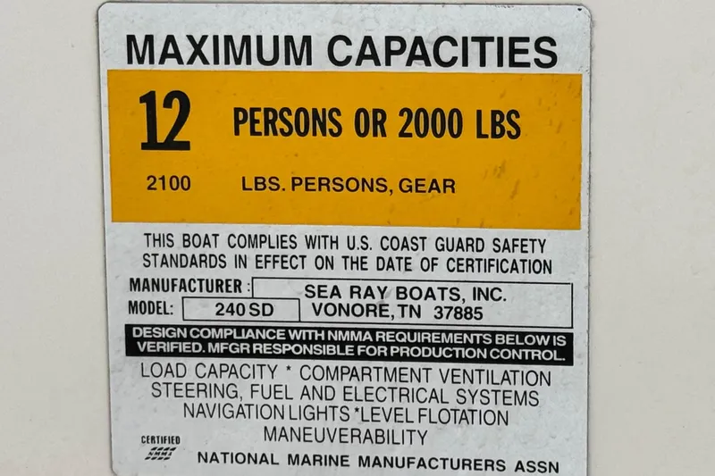 Slide: The Image of 2001 Sea Ray 240 Sundeck capacity label: 12 persons or 2000 lbs, safety compliance. - 39