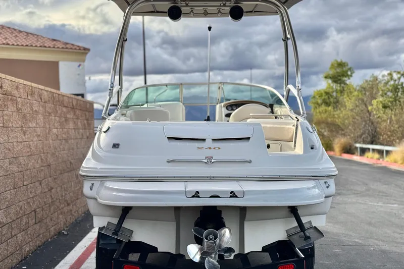 Slide: The Image of 2001 Sea Ray 240 Sundeck boat, rear view, parked on a road. - 4