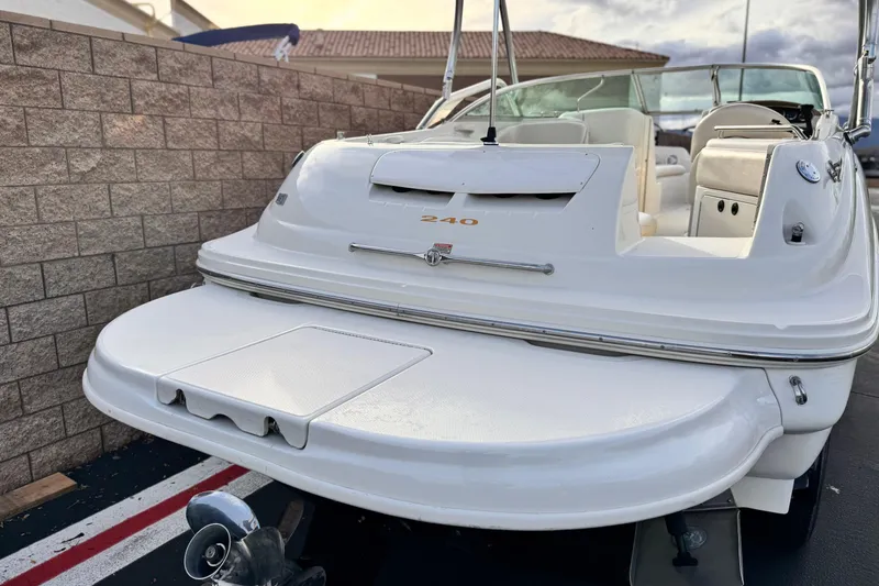 Slide: The Image of 2001 Sea Ray 240 Sundeck boat, rear view with swim platform and seating area. - 6