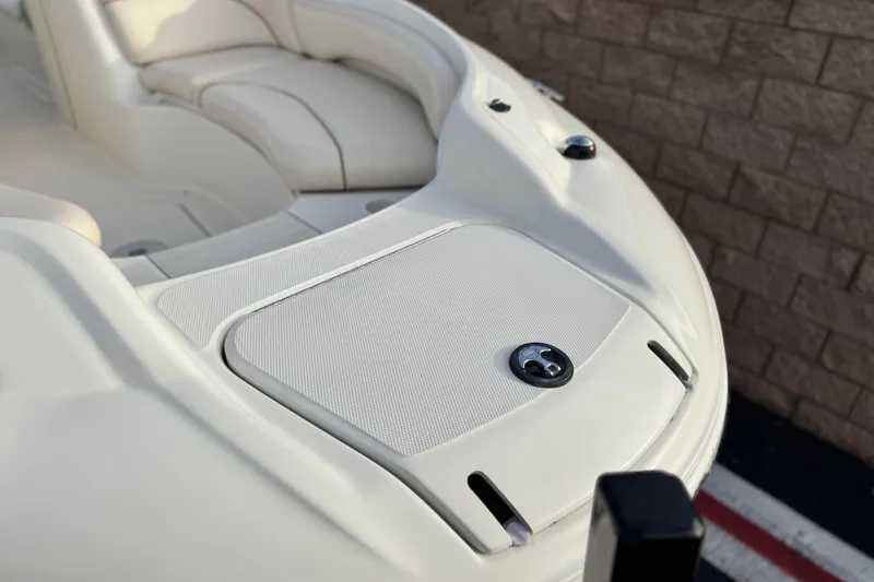 Slide: The Image of 2001 Sea Ray 240 Sundeck boat interior with beige seating and storage compartment. - 9