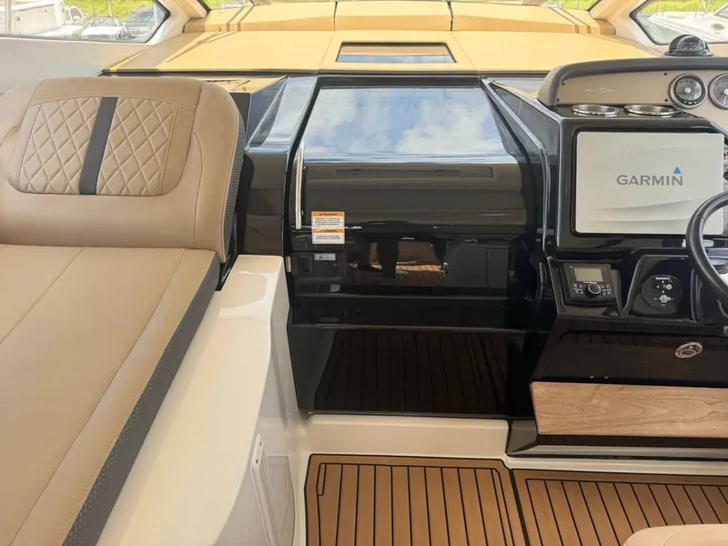 Slide: The Image of 2017 Sea Ray Sundancer 350 Coupe interior with Garmin navigation system and luxurious seating. - 13