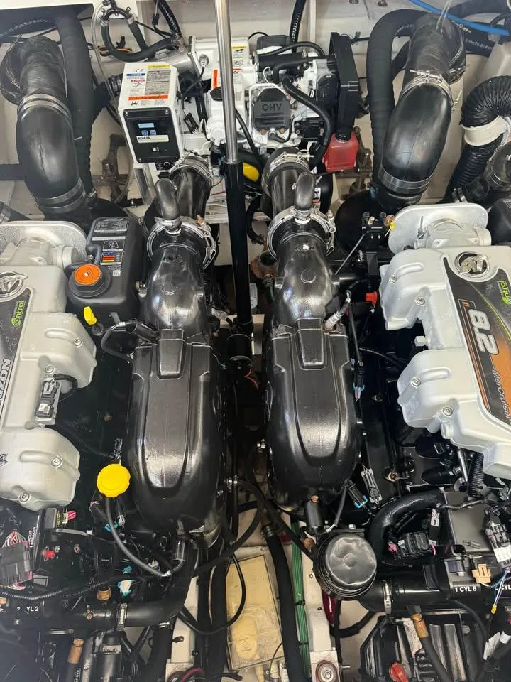 Slide: The Image of Engine room of a 2017 Sea Ray Sundancer 350 Coupe, showcasing dual inboard engines. - 19