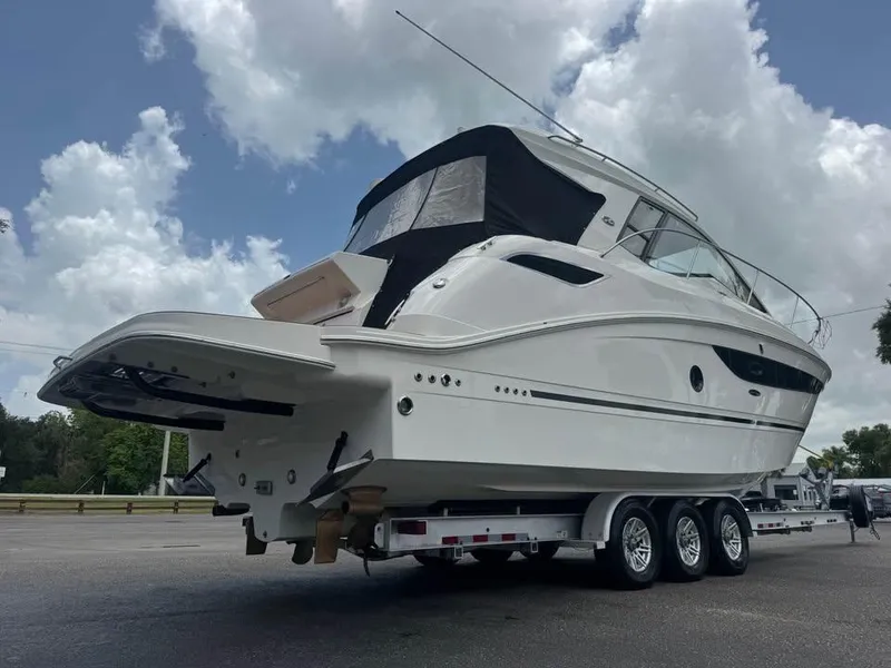 Slide: The Image of 2017 Sea Ray Sundancer 350 Coupe on trailer under cloudy sky. - 4