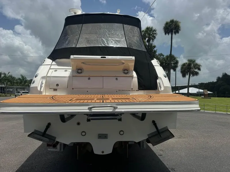 Slide: The Image of 2017 Sea Ray Sundancer 350 Coupe, rear view with swim platform, under cloudy sky. - 5