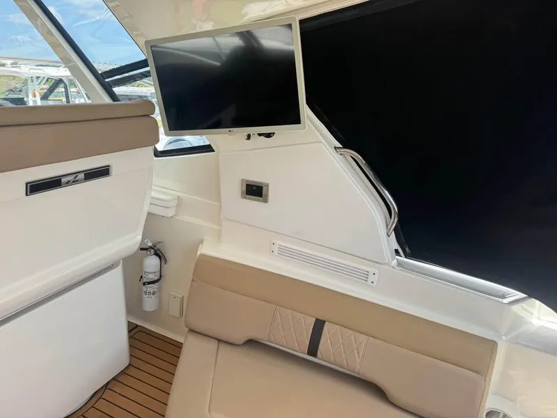 Slide: The Image of Interior of 2017 Sea Ray Sundancer 350 Coupe with TV and seating area. - 8