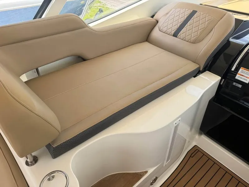 Slide: The Image of Luxurious seating on 2017 Sea Ray Sundancer 350 Coupe, featuring tan upholstery and elegant design. - 9