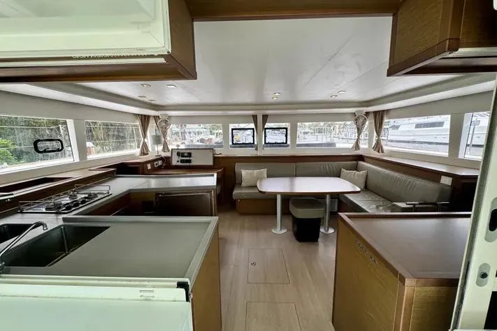Slide: The Image of Spacious interior of 2019 Lagoon 450 catamaran with modern kitchen and dining area. - 14