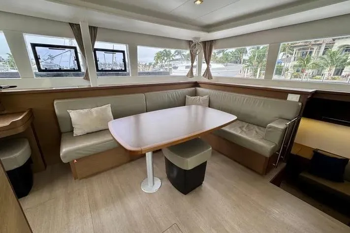 Slide: The Image of Interior of 2019 Lagoon 450 catamaran with spacious seating and large windows. - 15