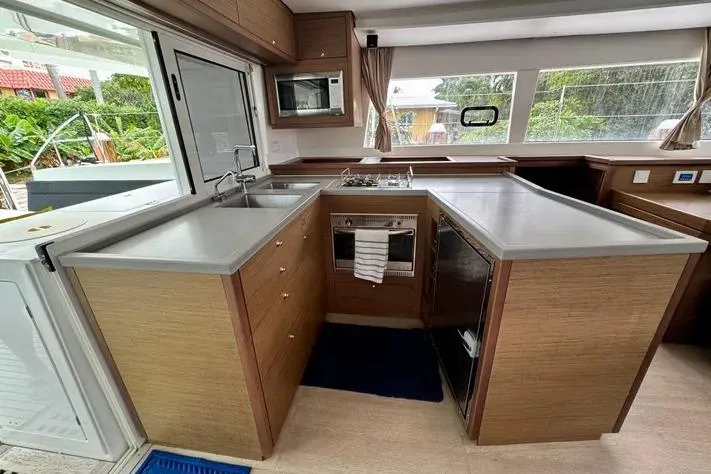 Slide: The Image of Modern kitchen interior of 2019 Lagoon 450 catamaran with sleek countertops and appliances. - 16