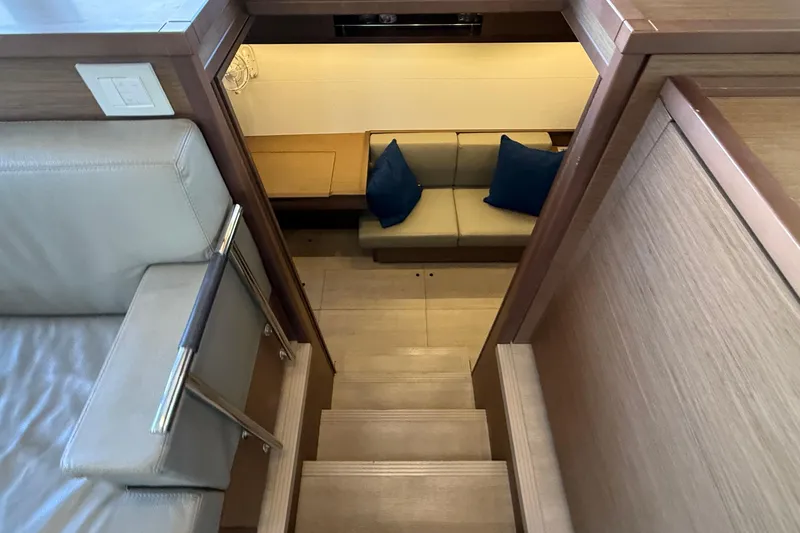 Slide: The Image of Interior view of 2019 Lagoon 450 yacht, featuring stairs and cozy seating area. - 17