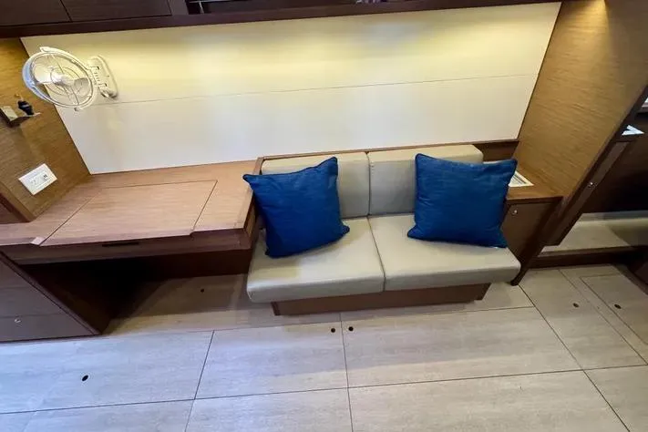 Slide: The Image of Interior of 2019 Lagoon 450 yacht with beige sofa and blue cushions. - 18