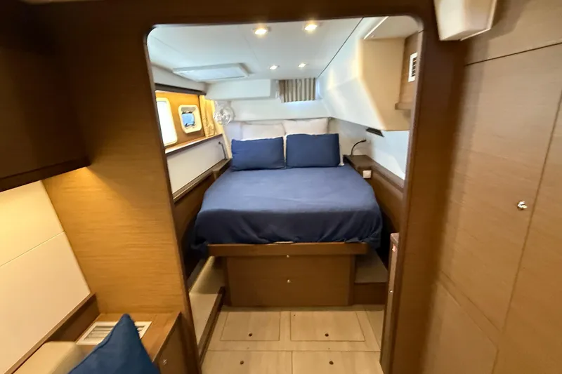 Slide: The Image of Luxurious cabin interior of 2019 Lagoon 450 yacht with cozy bed and wooden furnishings. - 20