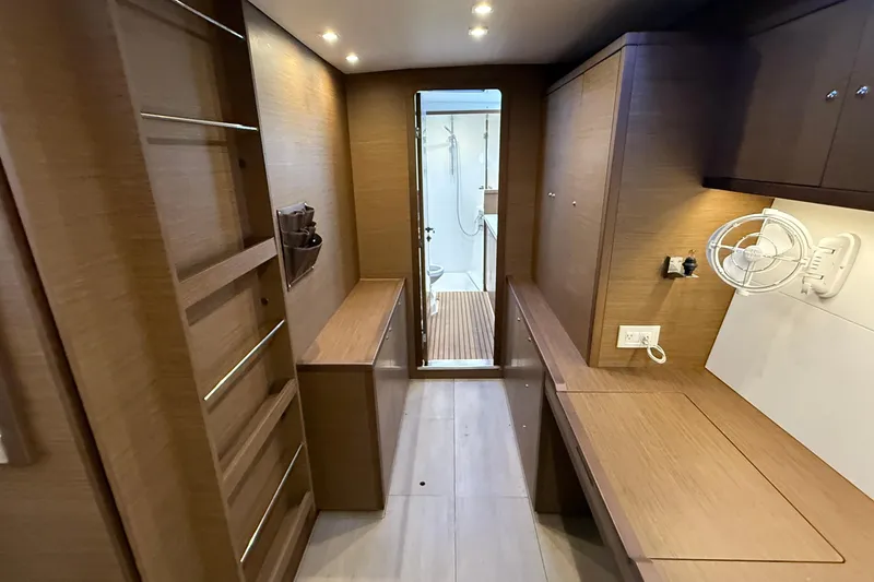 Slide: The Image of Interior of 2019 Lagoon 450 yacht, featuring wood paneling and modern amenities. - 22