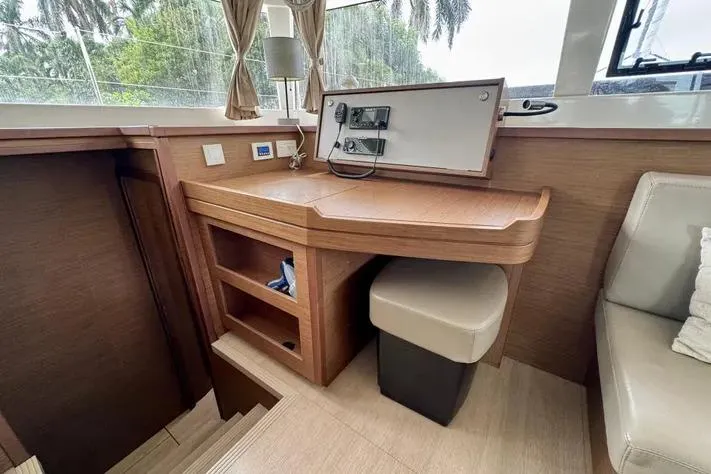 Slide: The Image of Interior of 2019 Lagoon 450 yacht with wooden desk and seating area. - 23