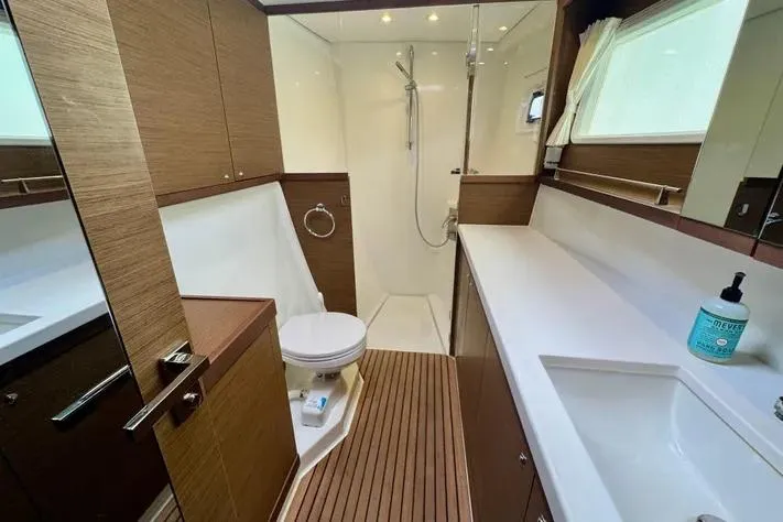 Slide: The Image of Luxurious bathroom in 2019 Lagoon 450 yacht with modern fixtures and wooden accents. - 24