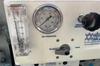 Slide: The Image of Control panel of a 2019 Lagoon 450 with pressure gauge and watermaker settings. - 25