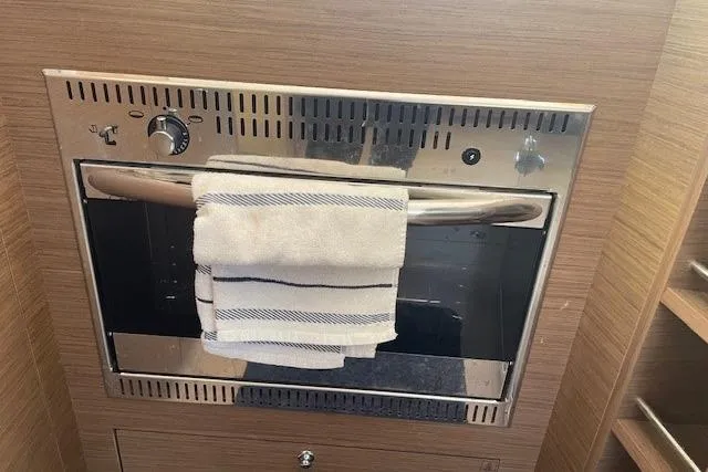 Slide: The Image of Built-in oven in Lagoon 450 yacht kitchen, 2019 model, with a towel on the handle. - 27