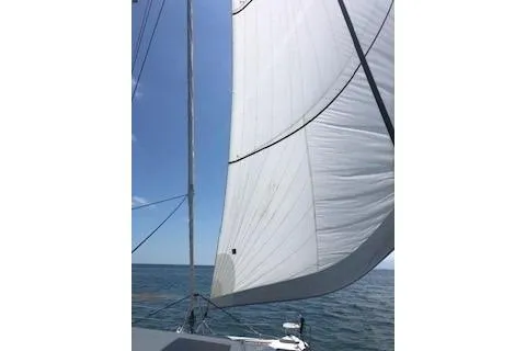 Slide: The Image of Sailing on a 2019 Lagoon 450 catamaran with white sails against a clear blue sky. - 31