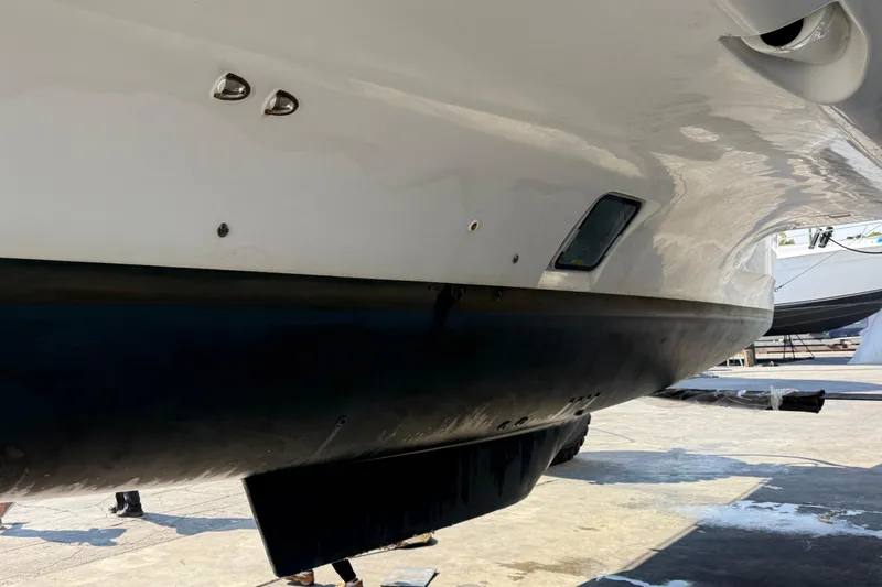 Slide: The Image of Close-up of a 2019 Lagoon 450 catamaran hull in a boatyard. - 42