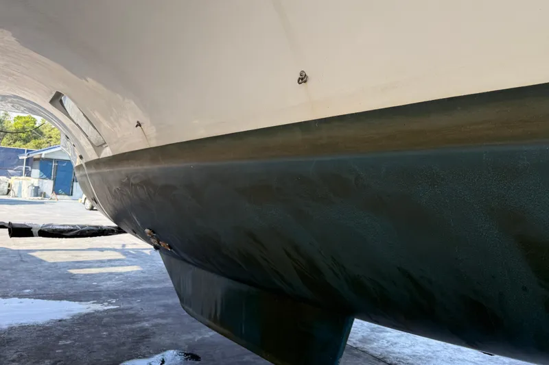 Slide: The Image of 2019 Lagoon 450 catamaran hull in dry dock, showcasing sleek design and structure. - 43