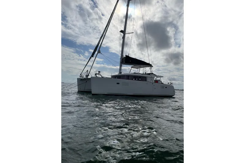 Slide: The Image of 2019 Lagoon 450F catamaran sailing on open water under a cloudy sky. - 47