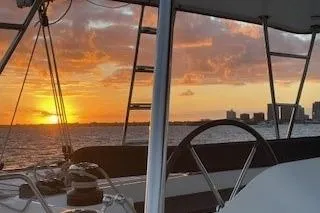 Slide: The Image of 2019 Lagoon 450 sailing at sunset with city skyline in the background. - 50