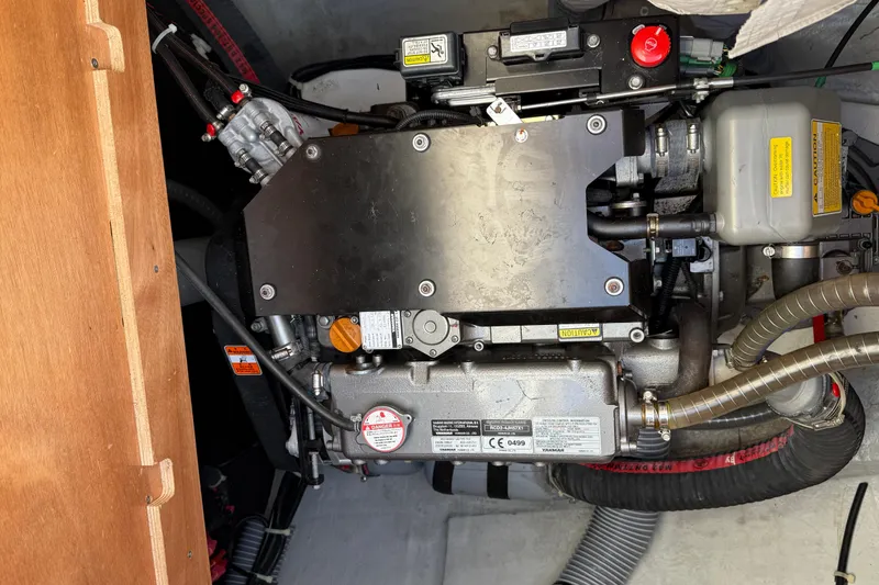 Slide: The Image of Engine compartment of a 2019 Lagoon 450 catamaran, showcasing mechanical components and hoses. - 51
