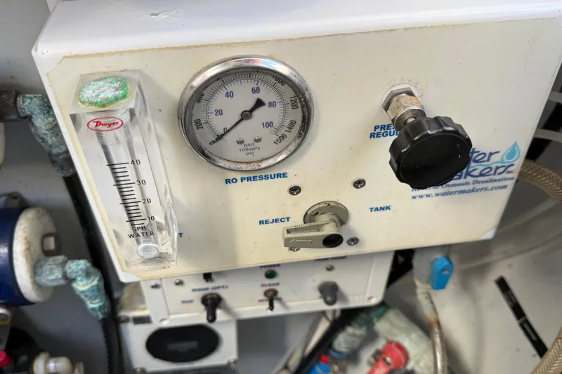 Slide: The Image of Control panel of a 2019 Lagoon 450 watermaker with pressure gauge and flow meter. - 60