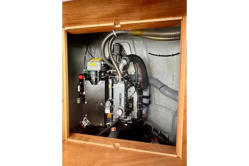 Slide: The Image of Engine compartment of a 2019 Lagoon 450 catamaran, showcasing mechanical components and wiring. - 62