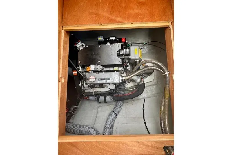Slide: The Image of Engine compartment of a 2019 Lagoon 450 catamaran, showcasing mechanical components and hoses. - 63