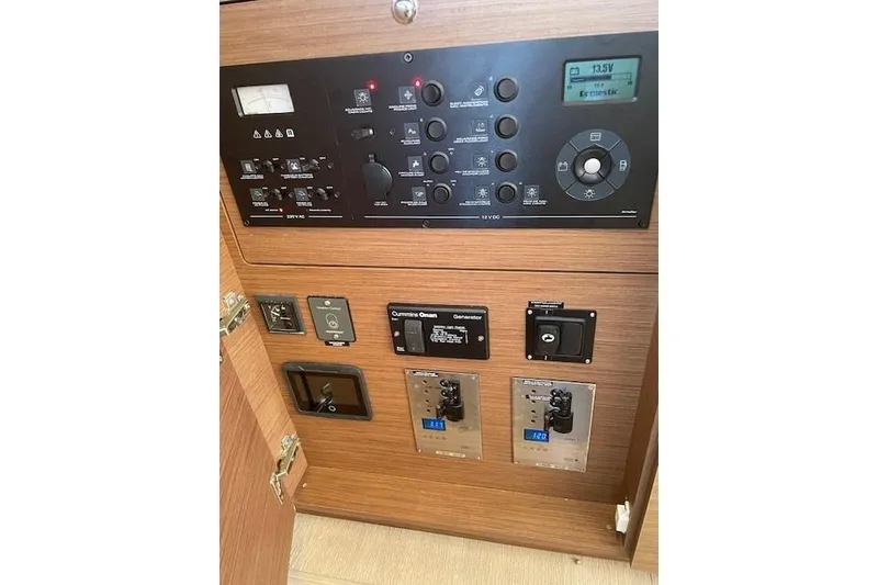 Slide: The Image of Control panel of a 2019 Lagoon 450 yacht, featuring various switches and displays. - 71
