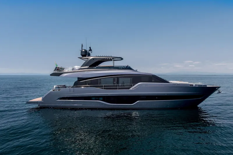 The Image of 2026 Cranchi Settantotto 78 yacht on calm ocean waters under clear blue sky. - 1