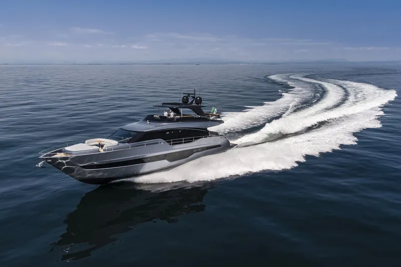 Slide: The Image of 2026 Cranchi Settantotto 78 yacht cruising on open water, leaving a wake behind. - 2