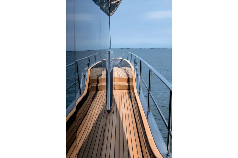 Slide: The Image of 2026 Cranchi Settantotto 78 yacht deck with sleek wooden finish and ocean view. - 36