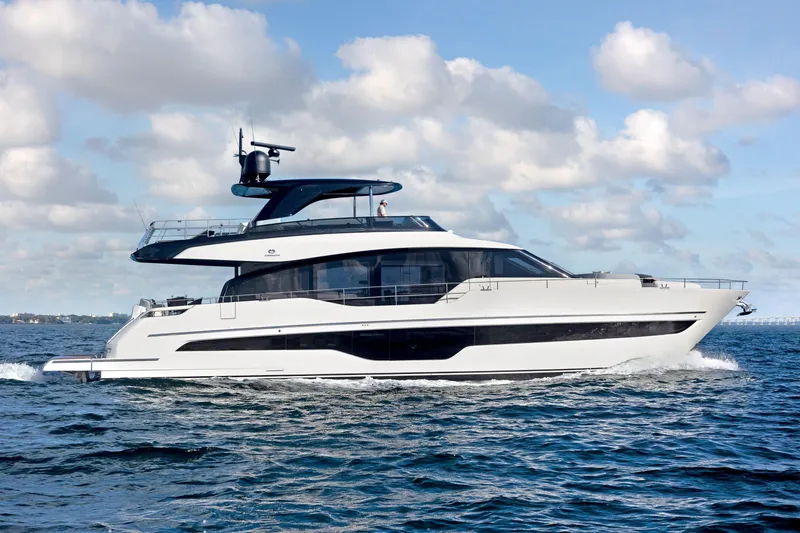 Slide: The Image of 2026 Cranchi Settantotto 78 yacht cruising on open water under a cloudy sky. - 48