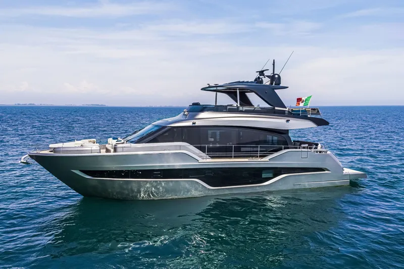 Slide: The Image of 2026 Cranchi Sessantasette 67 yacht cruising on open sea under clear skies. - 15