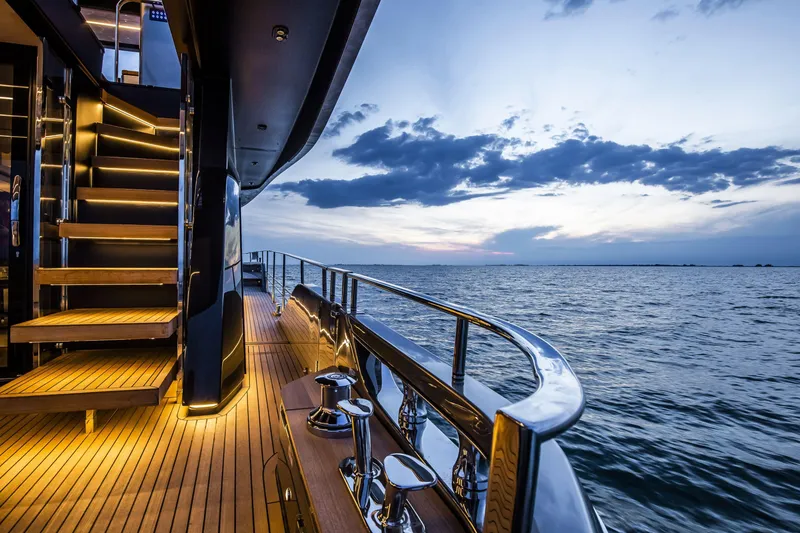 Slide: The Image of Luxury yacht Cranchi Sessantasette 67, 2026 model, with elegant deck lighting at sunset. - 17