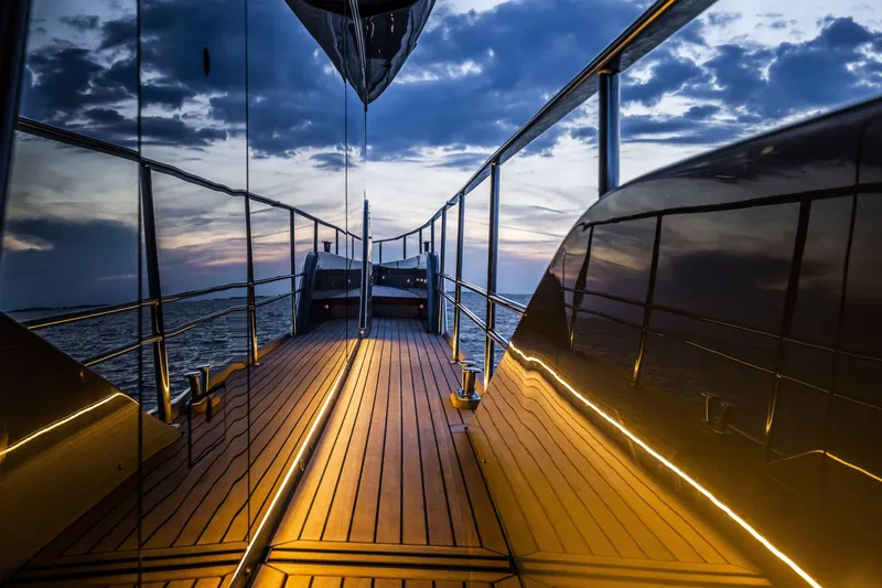 Slide: The Image of Luxurious 2026 Cranchi Sessantasette 67 yacht deck at sunset, reflecting serene ocean views. - 19