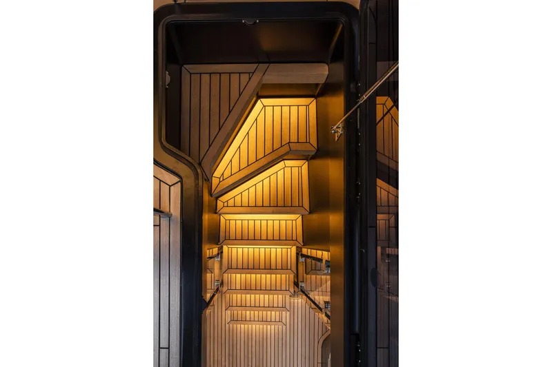 Slide: The Image of Interior of 2026 Cranchi Sessantasette 67 yacht with modern, illuminated wooden design. - 27