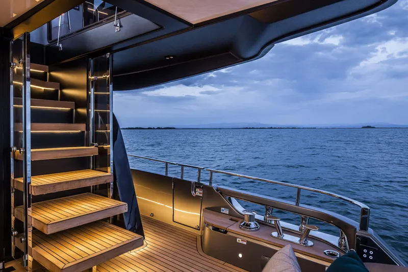 Slide: The Image of Luxurious 2026 Cranchi Sessantasette 67 yacht deck with elegant staircase and ocean view. - 32
