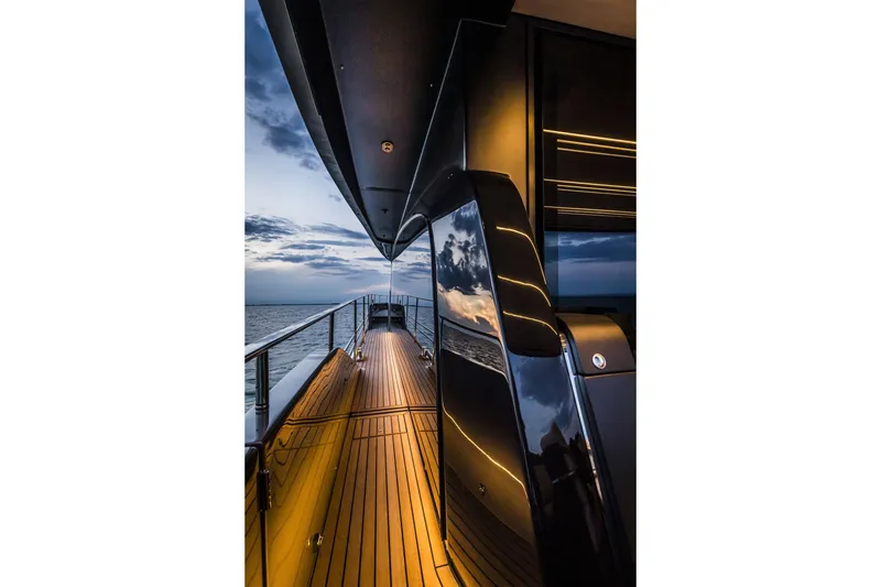 Slide: The Image of Luxurious 2026 Cranchi Sessantasette 67 yacht deck at sunset, featuring sleek design and ocean view. - 38