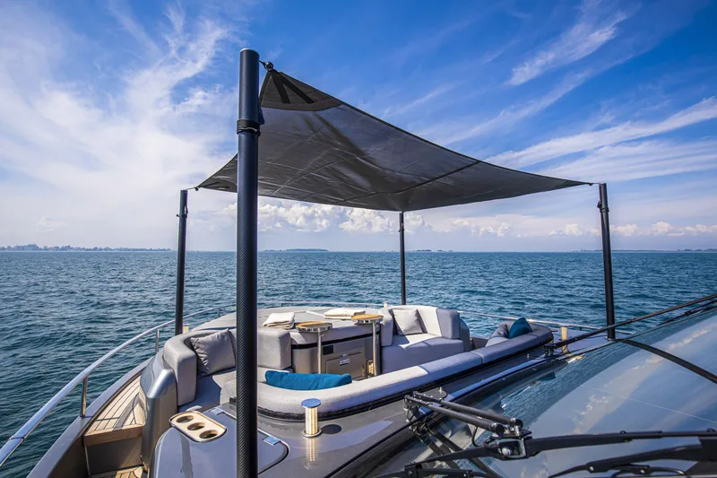 Slide: The Image of Luxurious 2026 Cranchi Sessantasette 67 yacht with shaded deck and ocean view. - 47