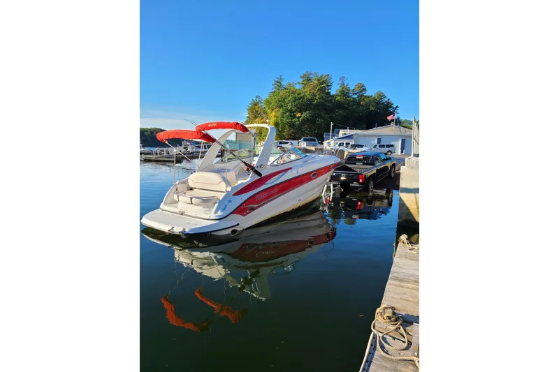 Slide: The Image of 2004 Crownline 270 CR boat docked at marina with clear blue sky. - 3