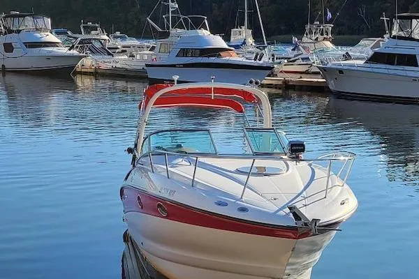 Slide: The Image of 2004 Crownline 270 CR boat docked in a marina with other vessels. - 4