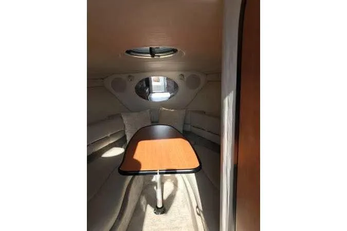 Slide: The Image of 2004 Crownline 270 CR cabin interior with table and seating. - 6