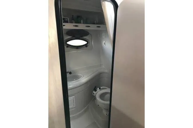 Slide: The Image of 2004 Crownline 270 CR boat bathroom interior with sink and toilet. - 8